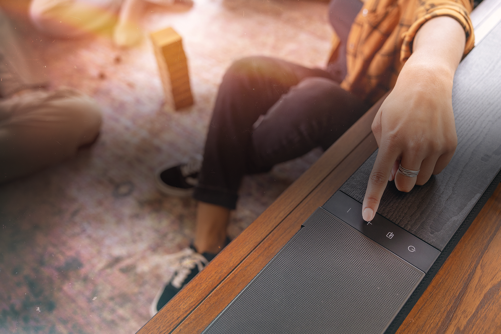 Klipsch Flexus womans finger pushing button on CORE 300 BK overlay 2000x1333