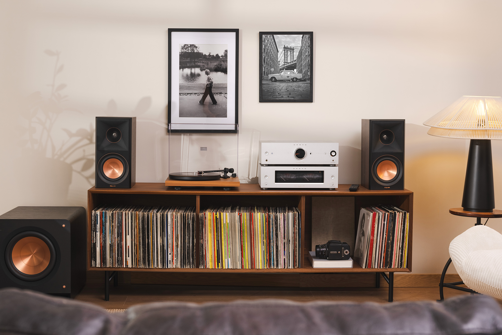 Klipsch Reference Premiere Bookshelf Speakers on media console beside turbtable and Onkyo P 80 Preamplifier and M 80 Power Amplifier 2000x1333
