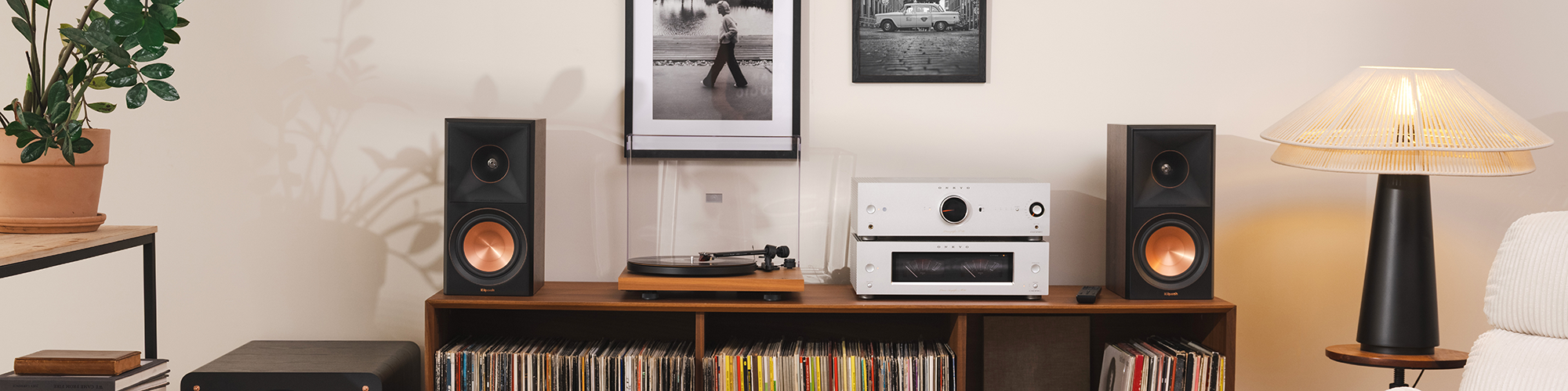 Klipsch Reference Premiere Bookshelf Speakers on media console beside turbtable and Onkyo P 80 Preamplifier and M 80 Power Amplifier 2000x500