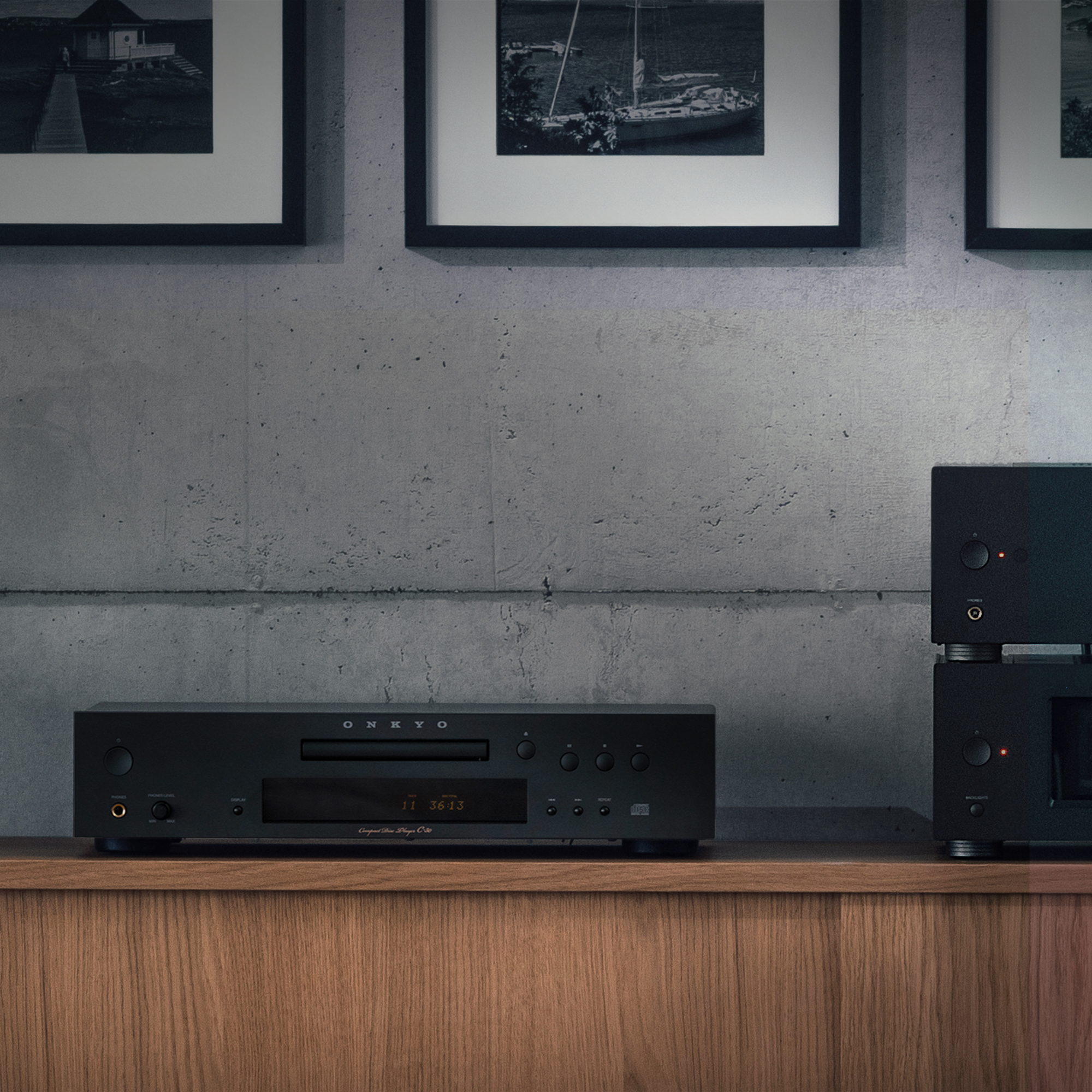 Onkyo C 30 CD Player closeup on wood cabinet beside small bonsai tree 2000x2000