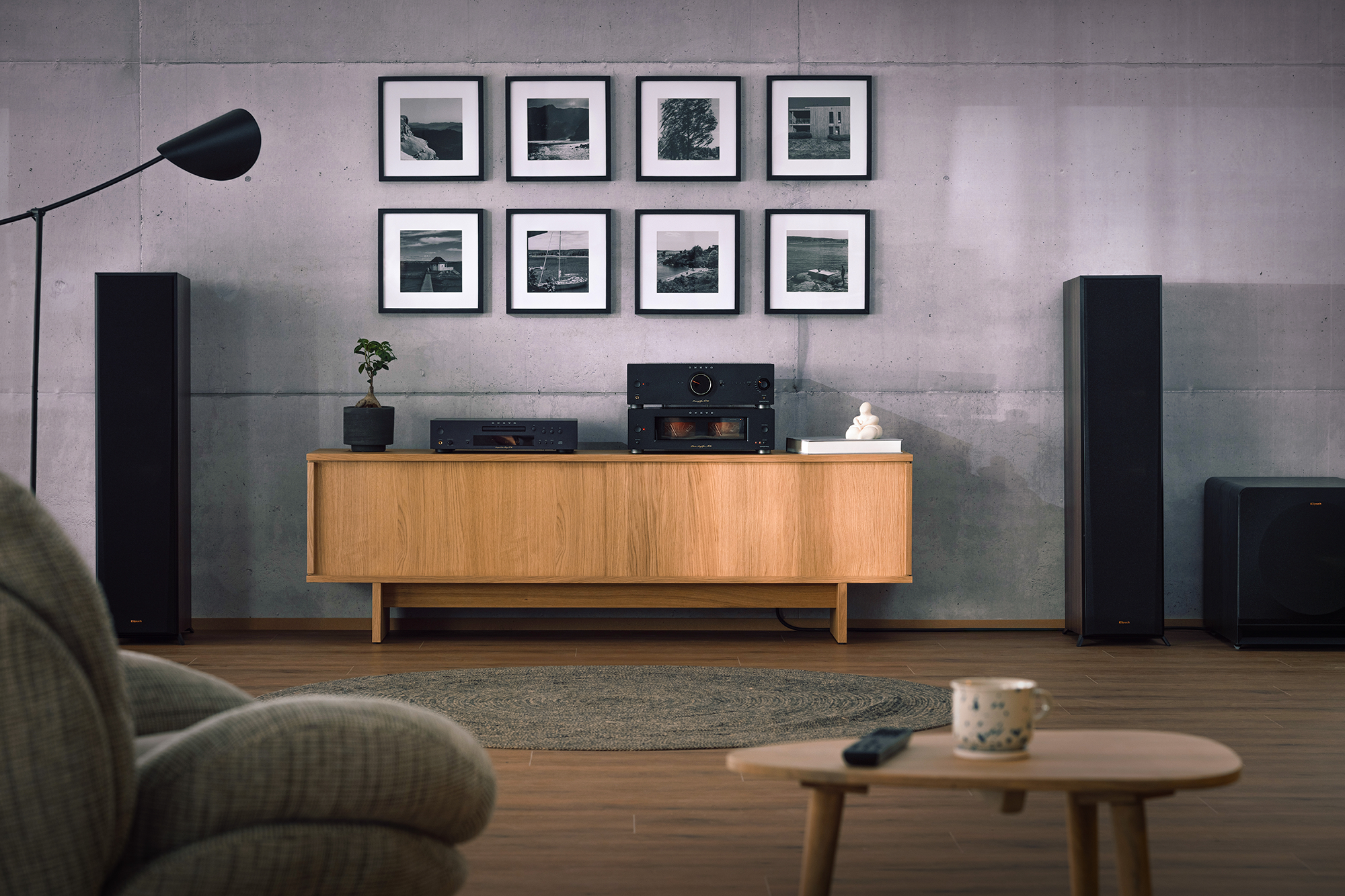 Onkyo Icon P 80 M 80 and C 30 black in listening room with Klipsch speakers gallery wall and lounge chair in blurred foreground 2000x1333