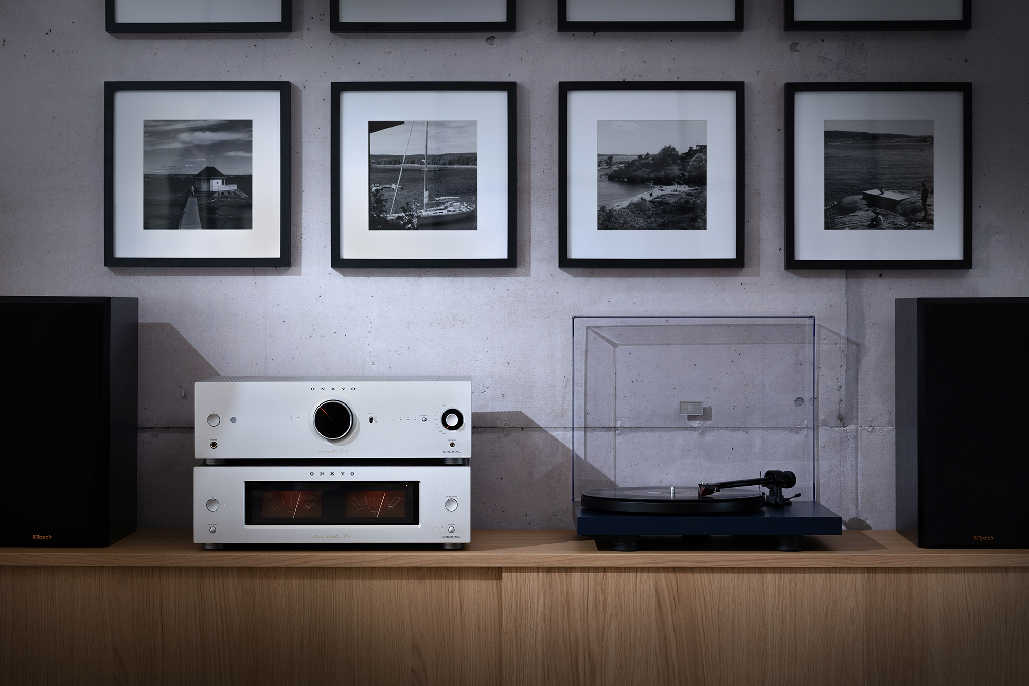 Onkyo Icon P 80 M 80 and turntable straight on between Klipsch bookshelf speakers on simple wood media console 2000x1333