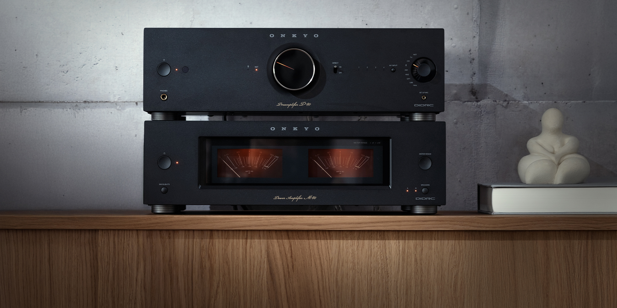 Onkyo Icon P 80 and M 80 black stacked beside small marble sculpture in listening room v02 2000x1000