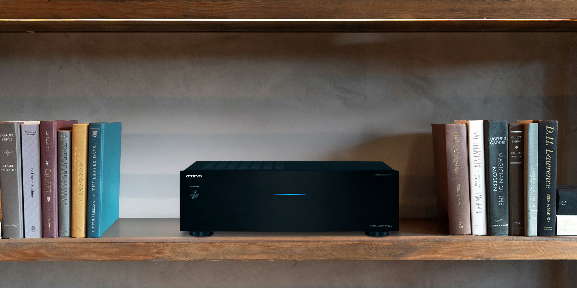 Onkyo M 5010 amplifier on a wood shelf beside books 2000x1000