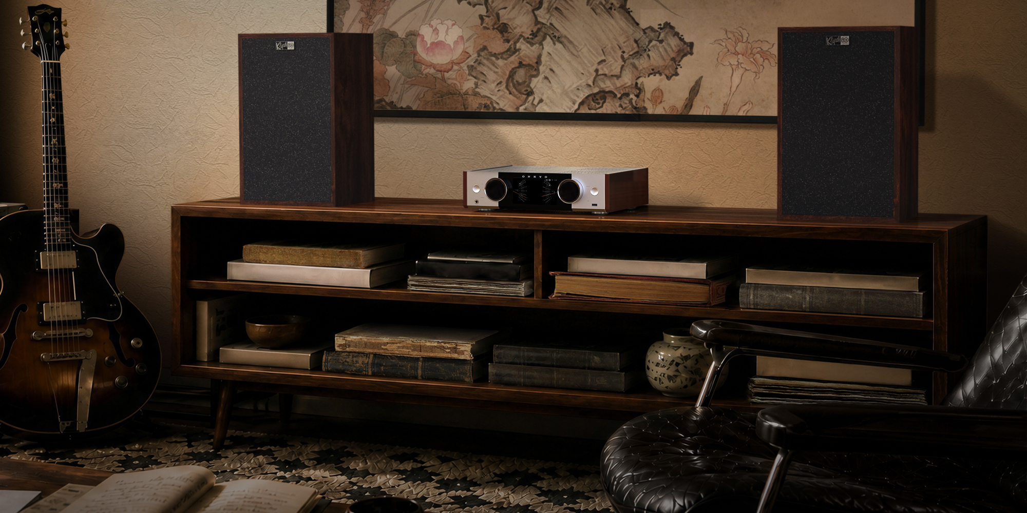Onkyo Muse80th 04 on bookshelf with speakers and art behind 2000x1000