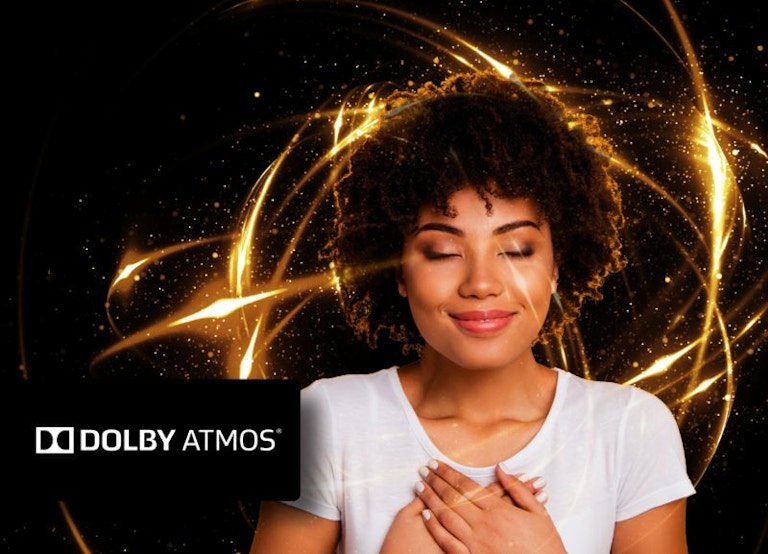 Woman with hands on her chest and Dolby Atmos label
