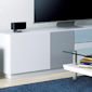 LS-3100 home audio system in a living room with white furniture and a blue carpet