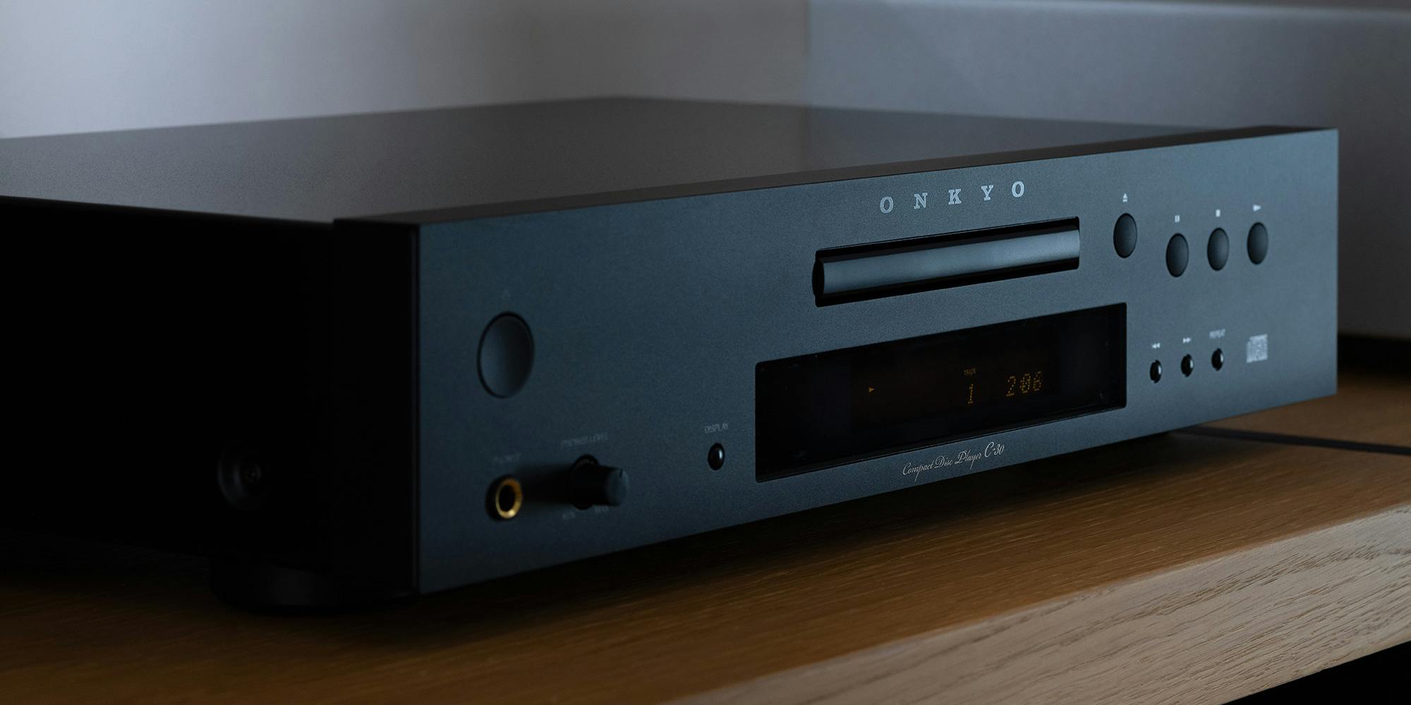 Onkyo C 30 CD Player angled closeup on wood shelf in moody light 2000x1000