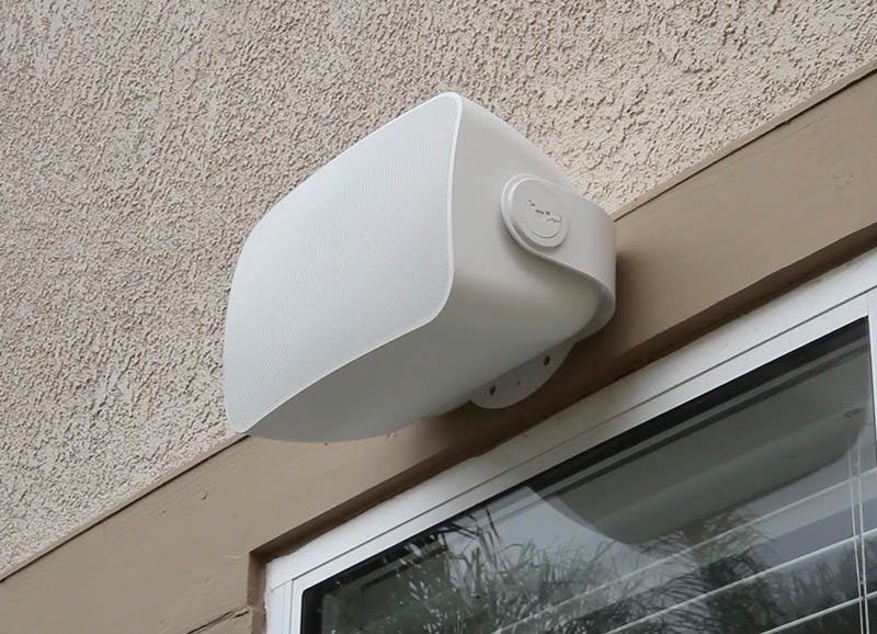 sonos outdoor white speaker on side of house outside