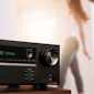 onkyo tx-sr494 av receiver on table with couple dancing in background